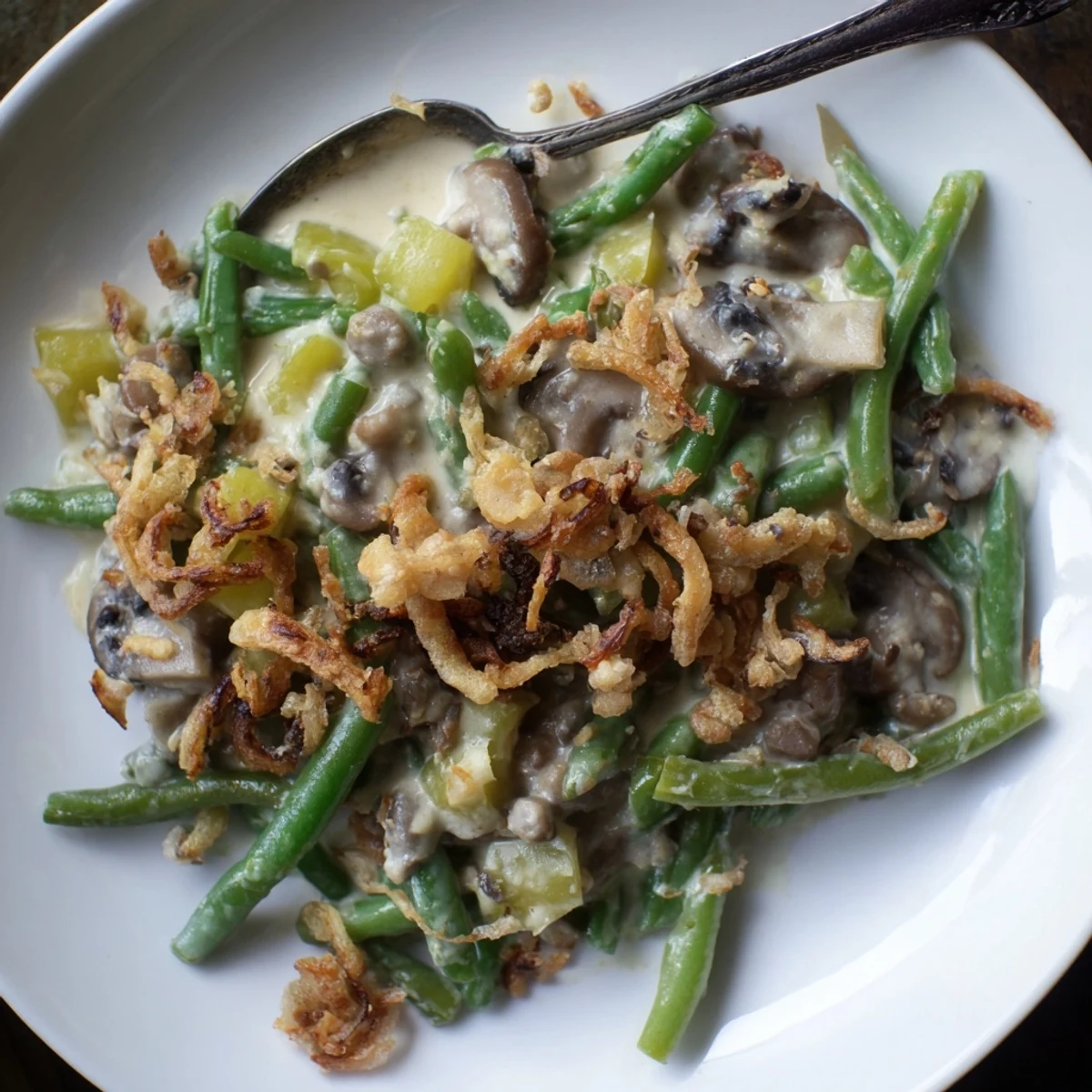 Golden-brown Old-School Green Bean Casserole garnished with crunchy fried onions, ideal for holidays.