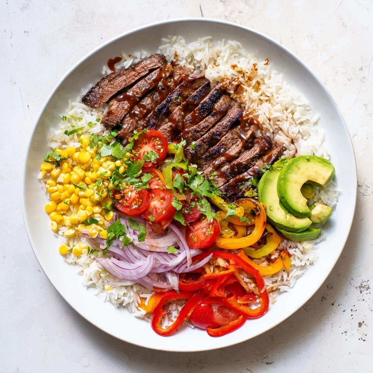 A delicious serving of BBQ Steak Fajita Bowl with juicy, grilled steak, and crunchy vegetables, garnished with fresh cilantro.