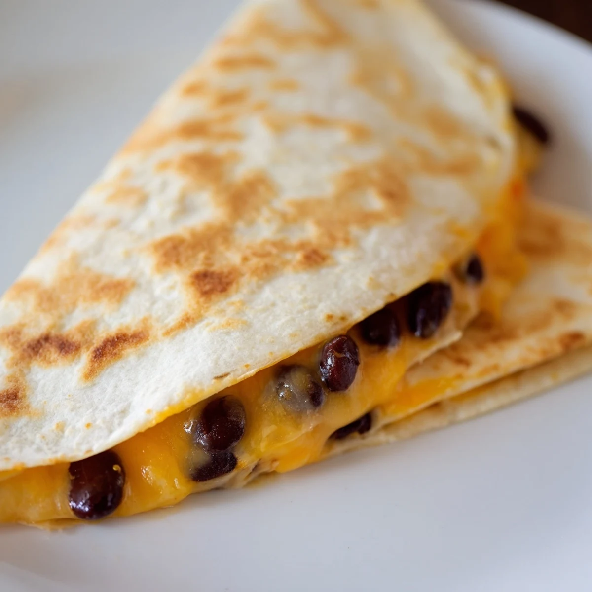 Golden, crispy bean & cheese quesadillas, oozing melted cheese, ready now with sour cream and salsa.