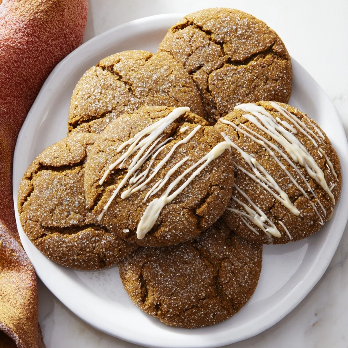 Warm, crackled Gingerbread Latte Cookies drizzled with creamy white chocolate, a delicious treat.
