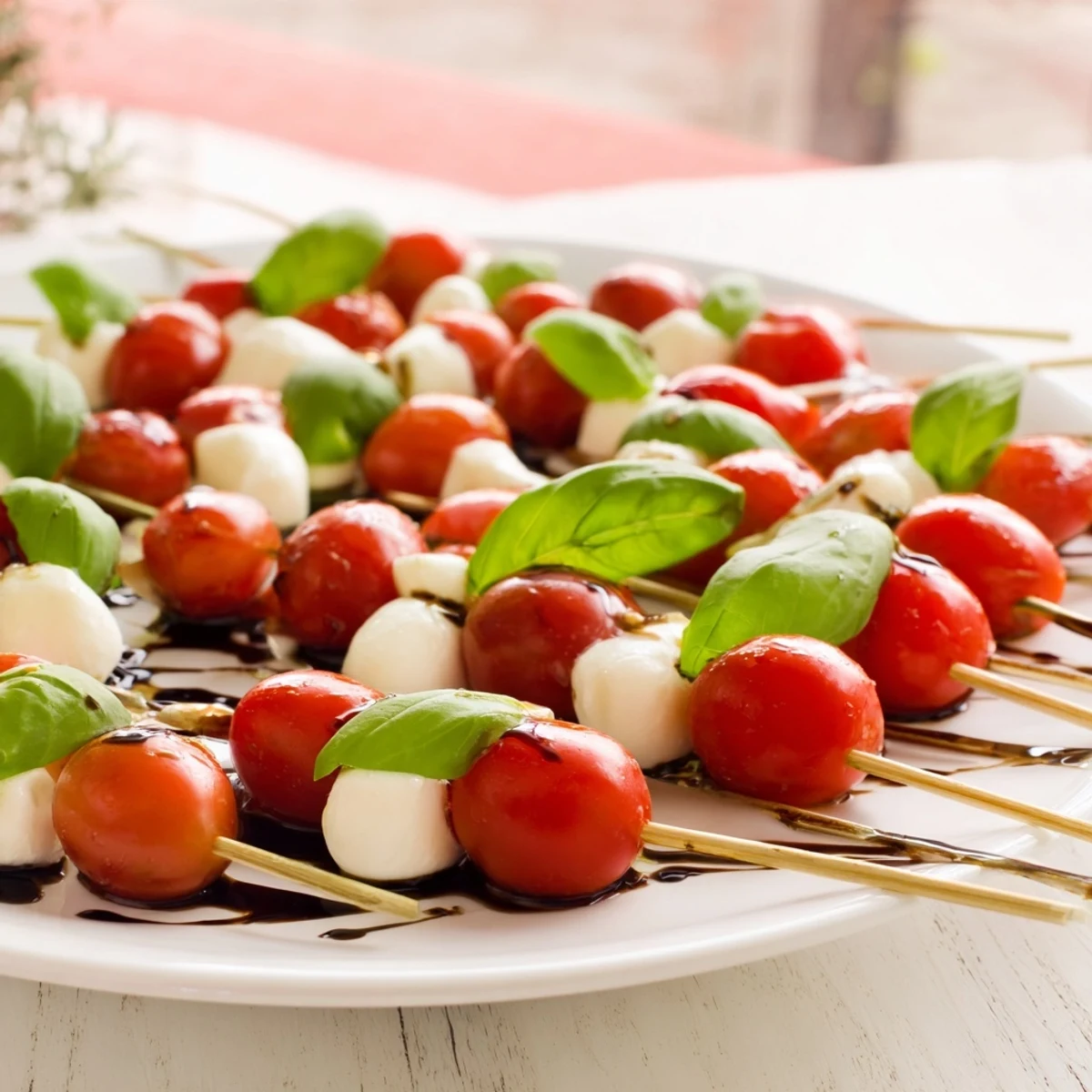 Easy Christmas Tree Caprese Skewers arranged on a platter, showcasing vibrant tomatoes, mozzarella, and rosemary.