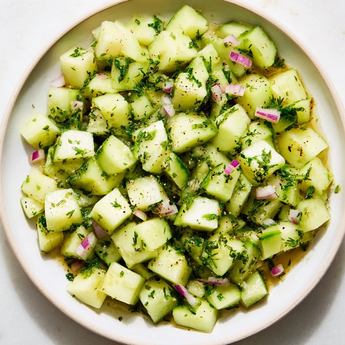 A refreshing close-up of the Simple Cucumber and Dill Chopped Salad with a zesty lemon dressing.