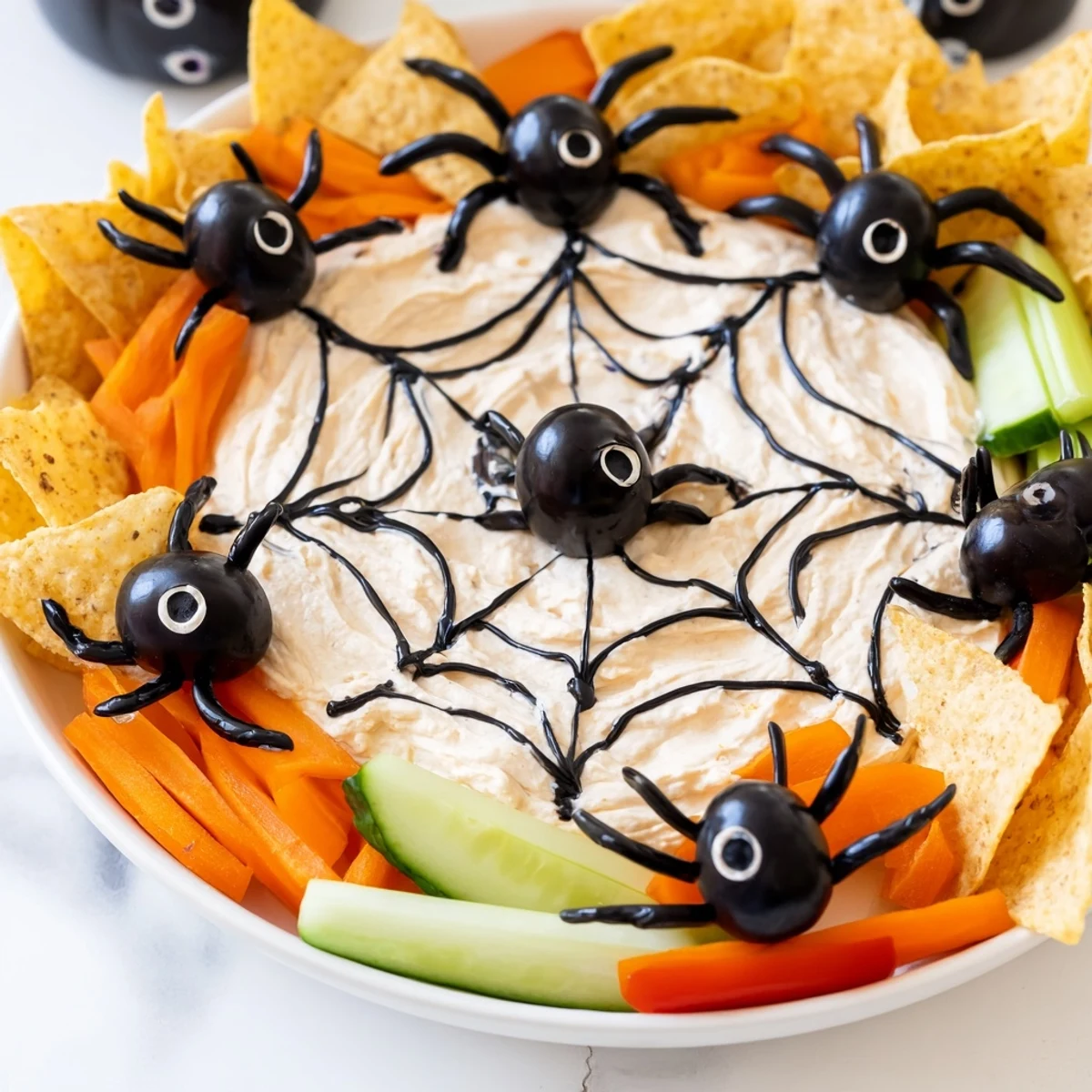 Creepy Crawly Spiderweb Platter, a visually striking Halloween appetizer with a sour cream spiderweb design.