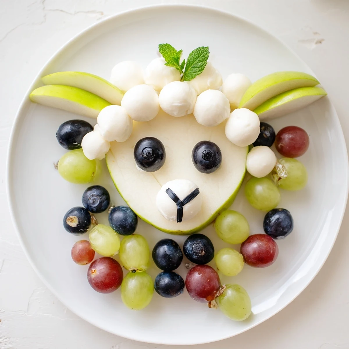 Lamb Face Fruit and Cheese Platter: A festive arrangement with pear face, mozzarella wool, and vibrant berries.