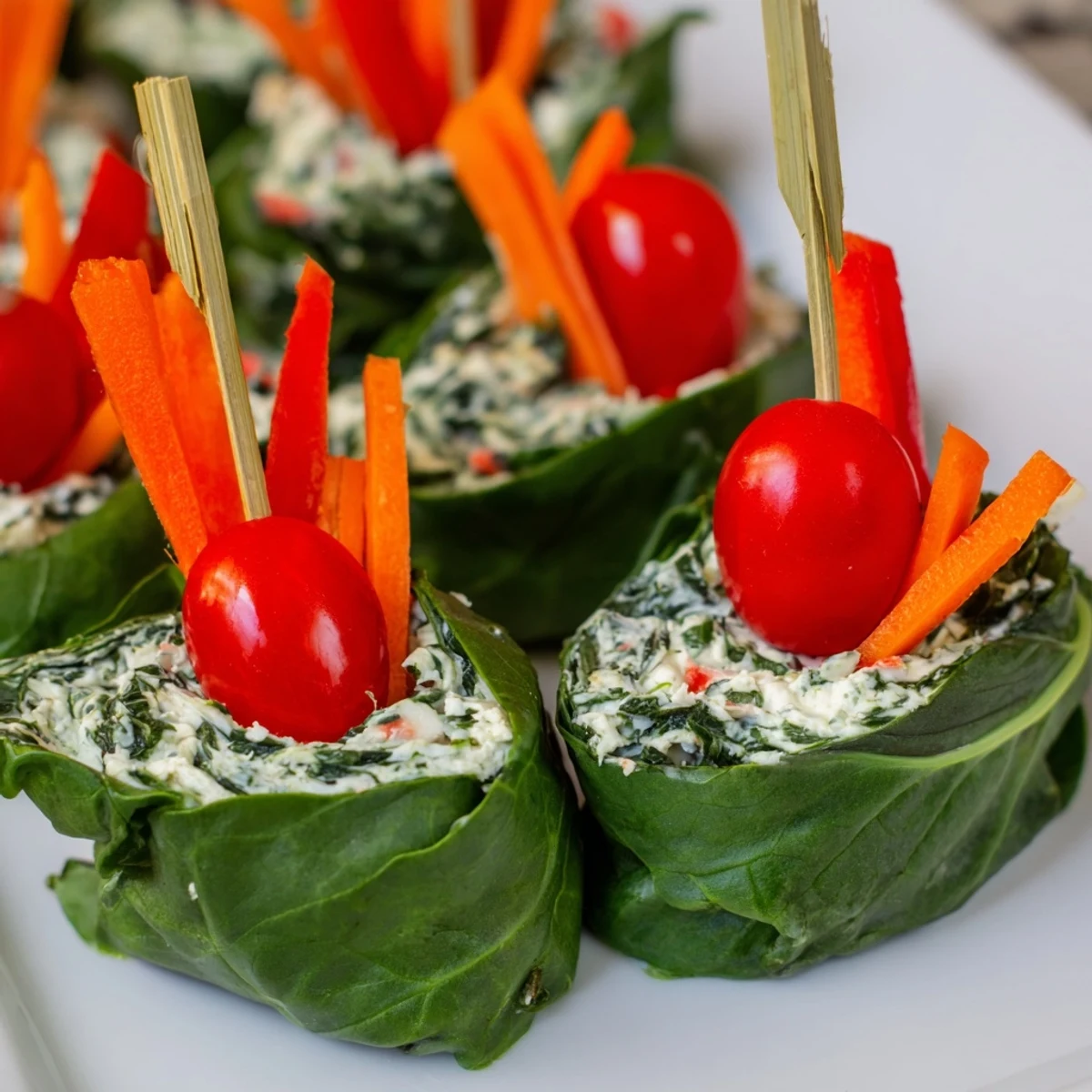 Beautiful Holly Leaf Spinach Wraps garnished with cherry tomatoes on a platter, ready to serve.