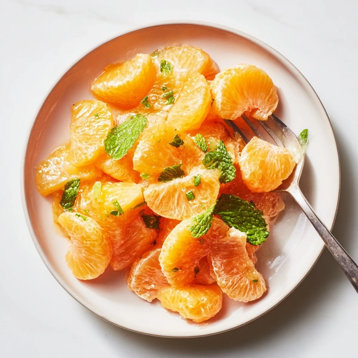 Vibrant clementine and mint winter fruit salad, bursting with juicy citrus and aromatic mint.