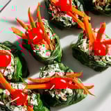 Freshly rolled Holly Leaf Spinach Wraps present with colorful vegetables for easy eating.