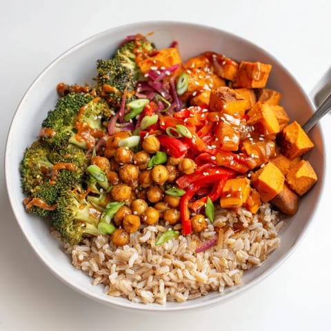 Colorful grain bowls featuring sweet potato and chickpeas, drizzled with miso-butter sauce.  