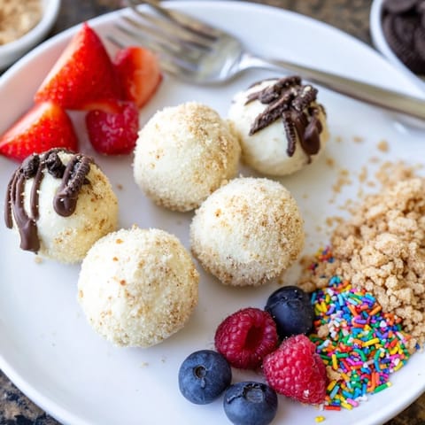 Interactive dessert board showcasing rich cheesecake bites, drizzled with chocolate ganache and fruits.  