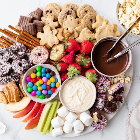 Sweet mini cupcakes and vibrant fruits enhance the delicious dessert boards display.  