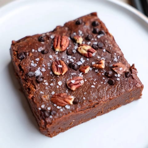 Warm, rich sweet potato brownies with melted chocolate chips, perfect for a gluten-free dessert treat.