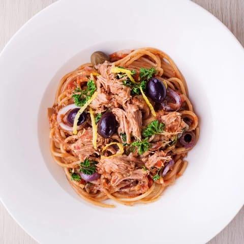 Flaky tuna, briny olives, and capers mingle in this delicious Pasta with Tuna, Olives & Capers.