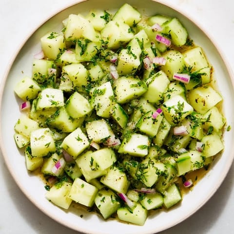 A refreshing close-up of the Simple Cucumber and Dill Chopped Salad with a zesty lemon dressing.