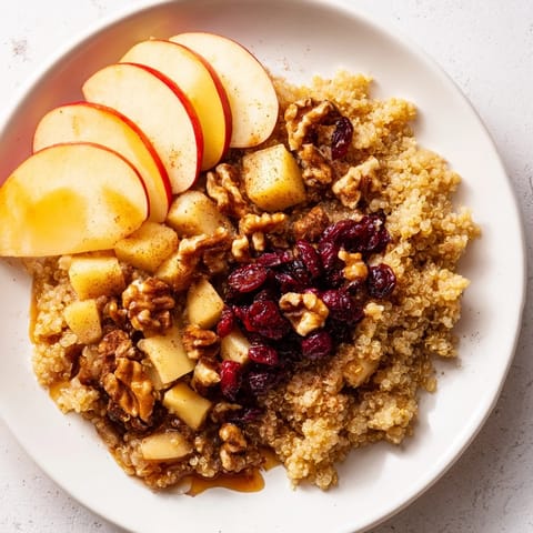 A close-up of a warm Apple Cinnamon Quinoa Bowl, beautifully garnished, ready to enjoy this morning.