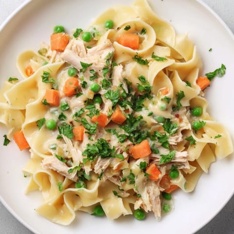 Spring Chicken Noodle Skillet in a warm skillet garnished with fresh parsley, perfect for a family dinner.