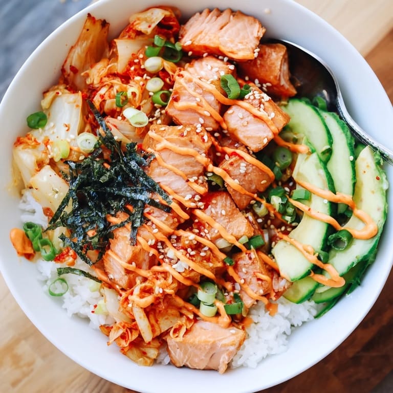 Deliciously crispy salmon on a bed of golden rice with vibrant toppings.  