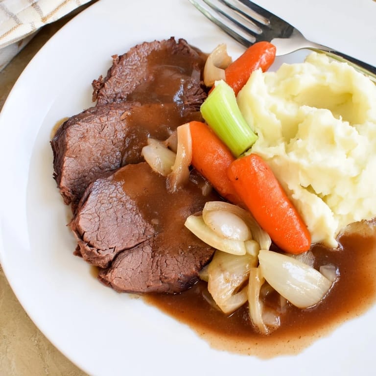 Hearty slow cooker pot roast, fall-apart beef served with creamy mashed potatoes for a flavorful dinner.
