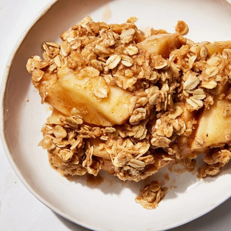 Homemade Apple Crisp, a delicious dessert with bubbling apples, is ready to serve warm.